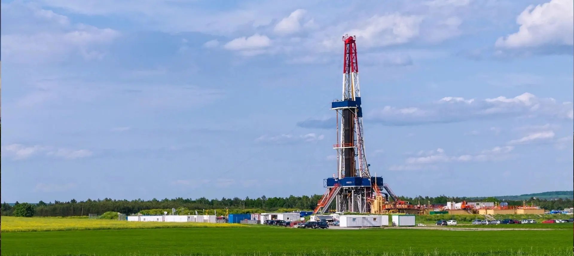 A drilling rig in the middle of an open field.