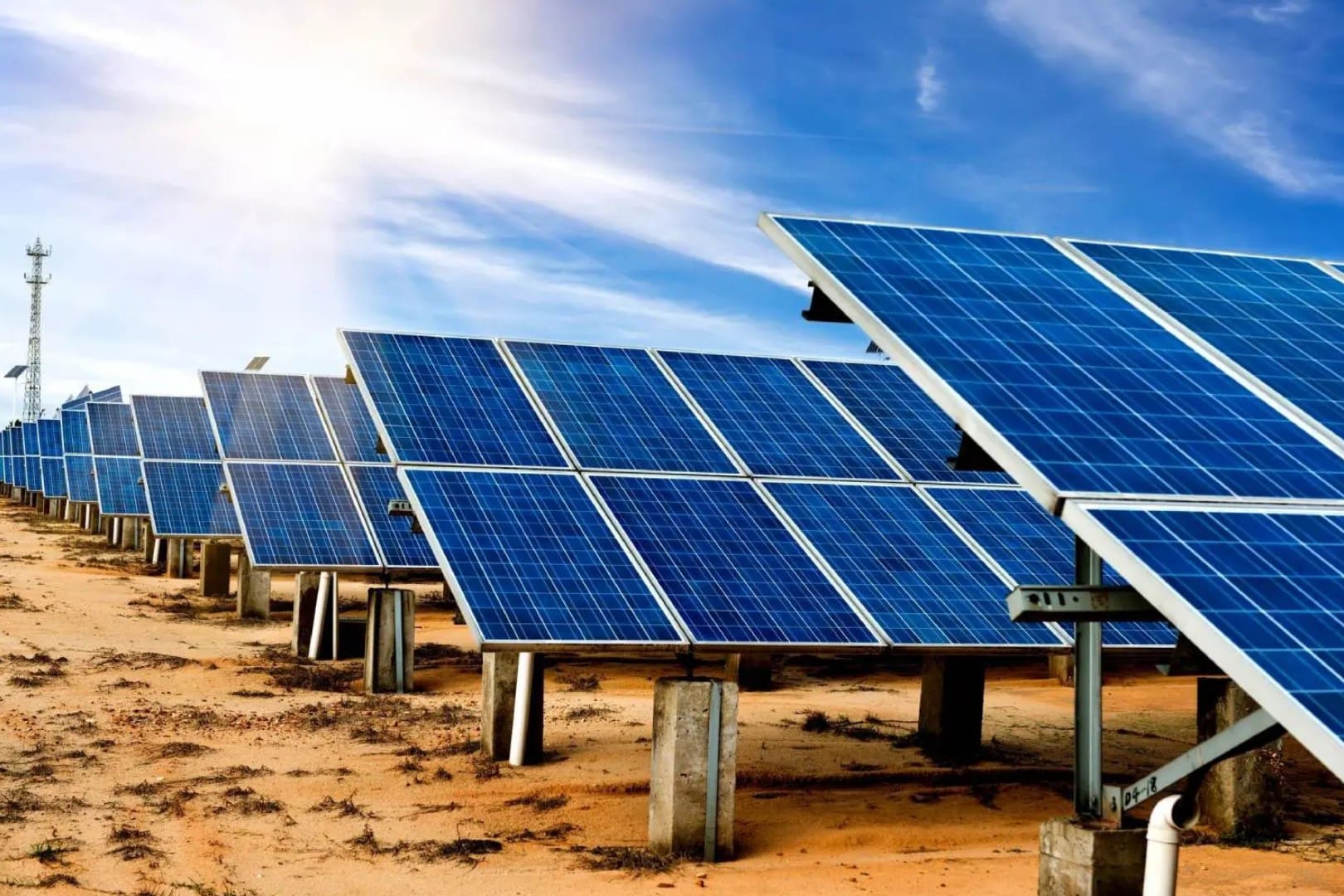 A group of solar panels sitting in the desert.