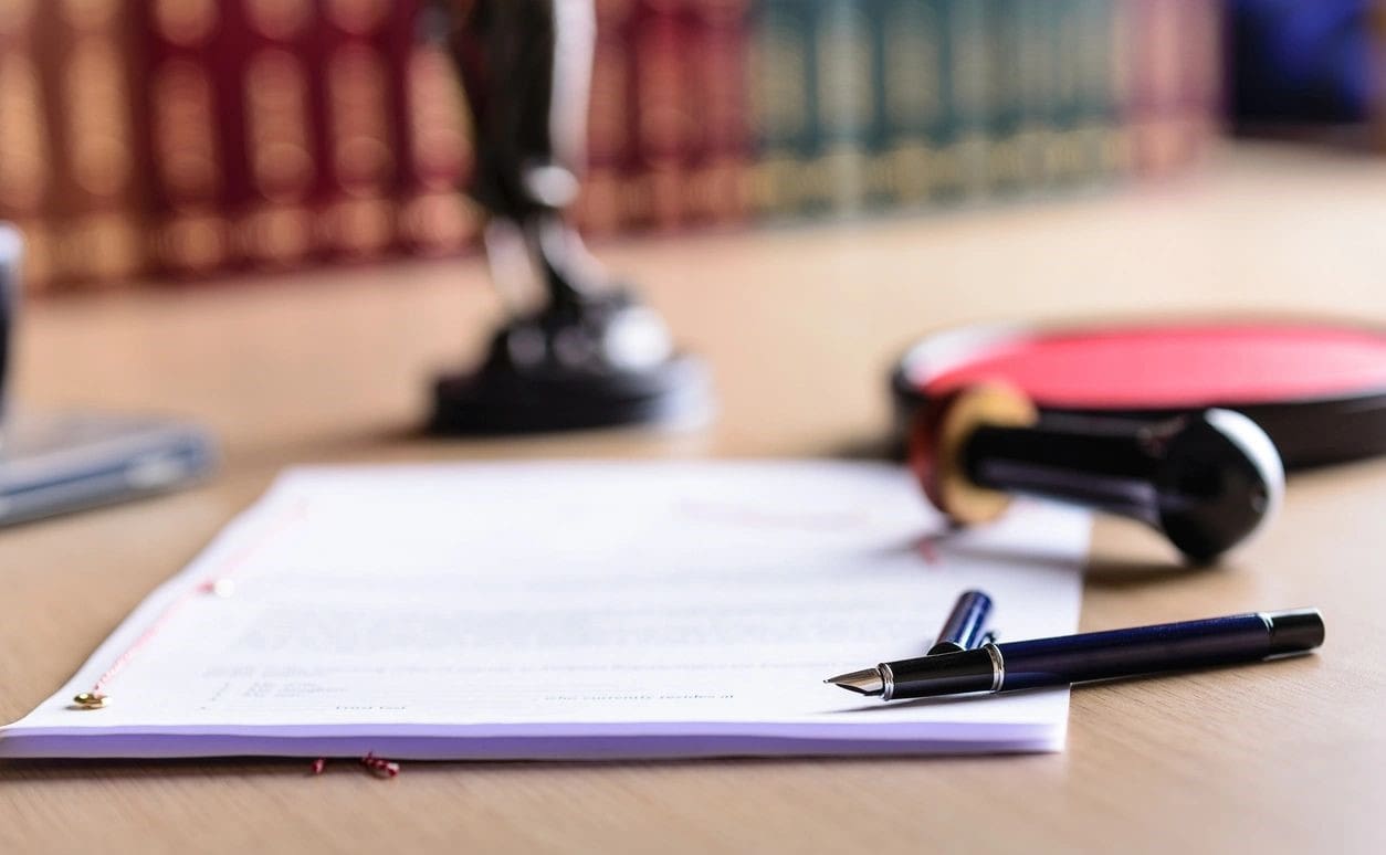 A pen and paper sitting on top of a table.